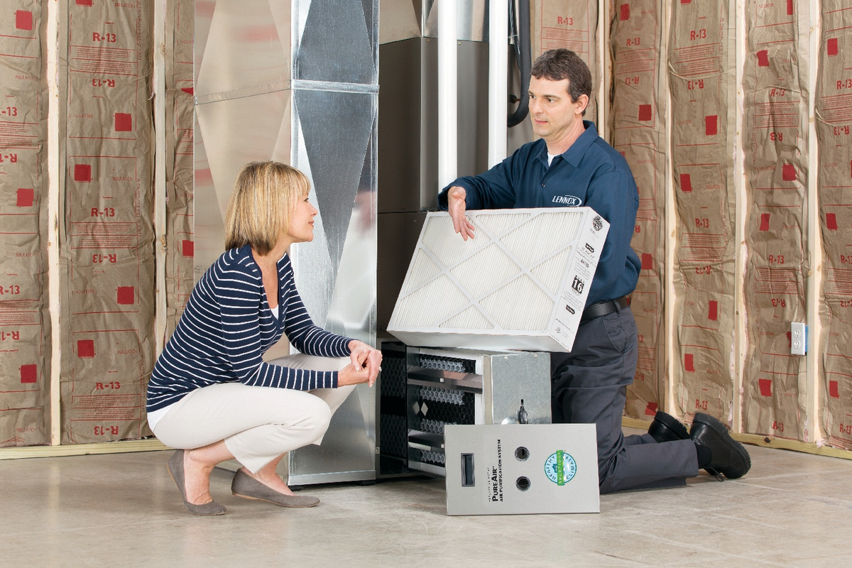 Technician testing indoor air quality equipment in a home